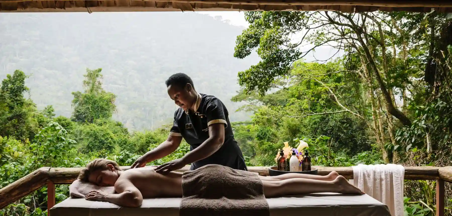 Outdoor spa treatment overlooking lush rainforest landscape