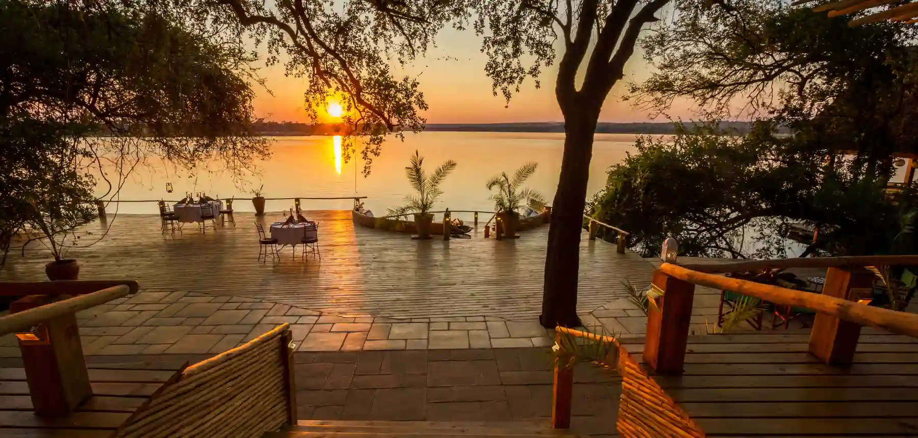 Luxury lodge deck overlooking a river at sunset in Africa