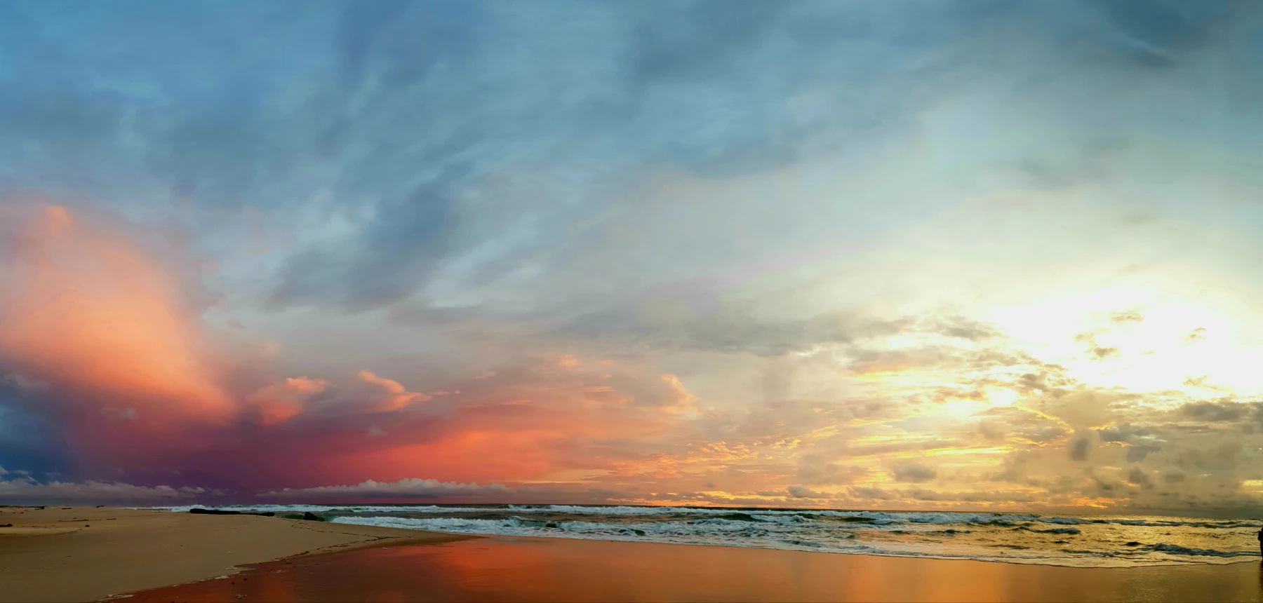 Colourful sunrise over beach and ocean waves