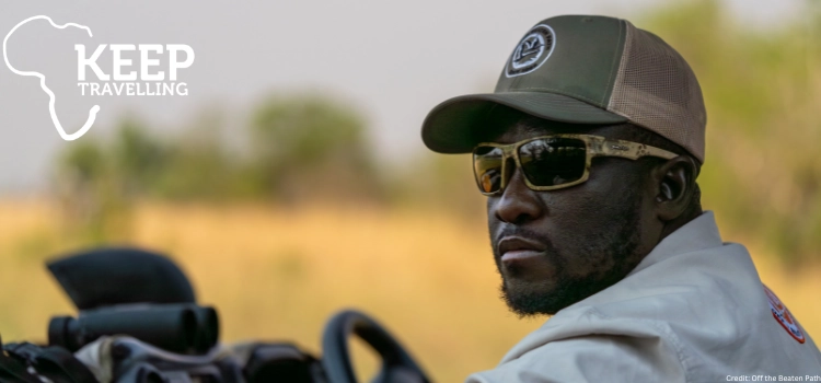 Safari guide in sunglasses driving through the Botswana bush