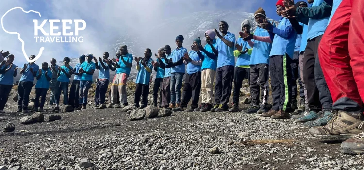 Guides and porters supporting climbers on Mount Kilimanjaro