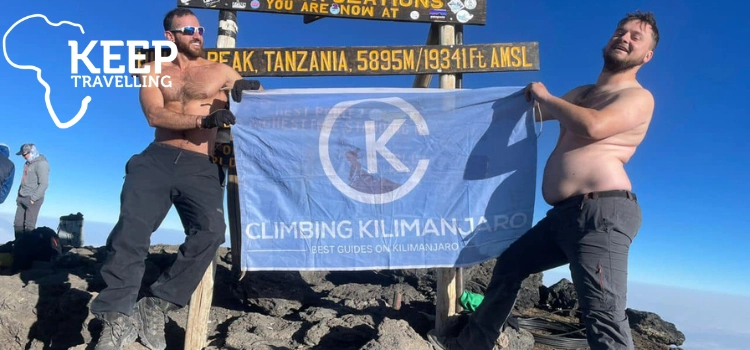 Climbers celebrating at the Mount Kilimanjaro summit in Tanzania