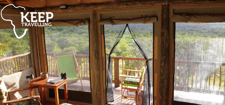Interior of a Hodi Hodi safari room opening onto a private balcony with bush views