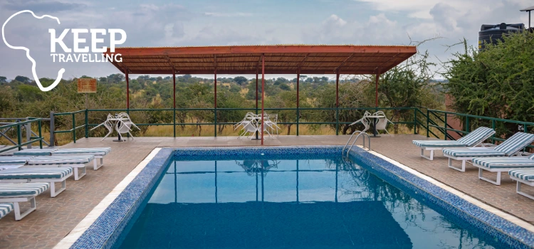 Swimming pool and sun loungers overlooking the bush at Serengeti Safari Lodge in Tanzania