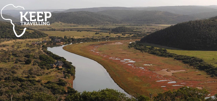 Wide view of a river winding through the biodiverse landscape of Kariega Game Reserve